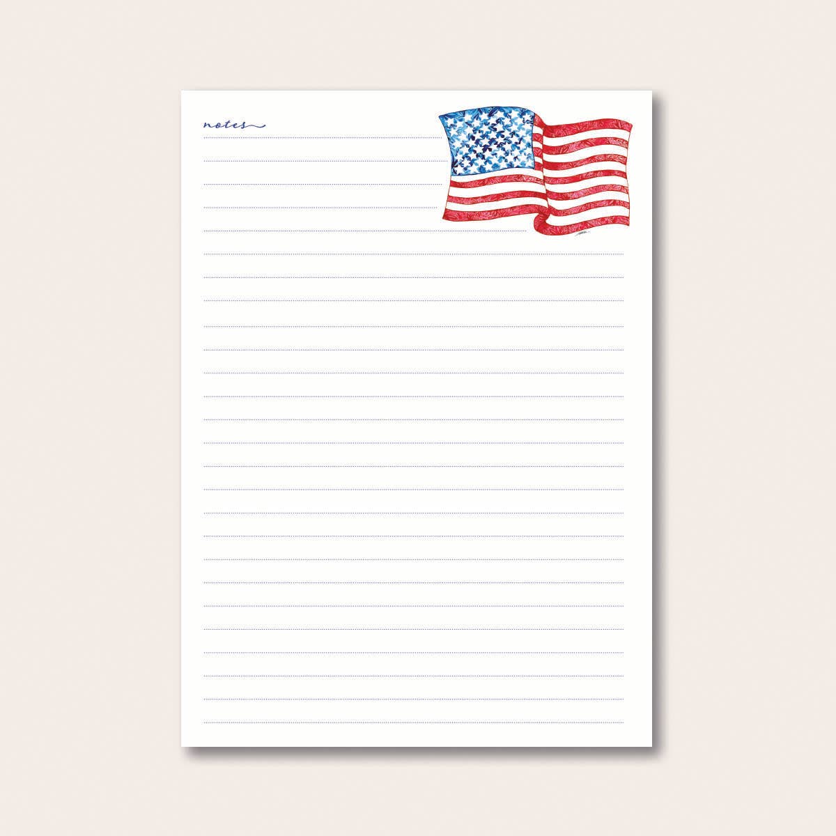 Notepad with an American flag design at the top on a light beige background.