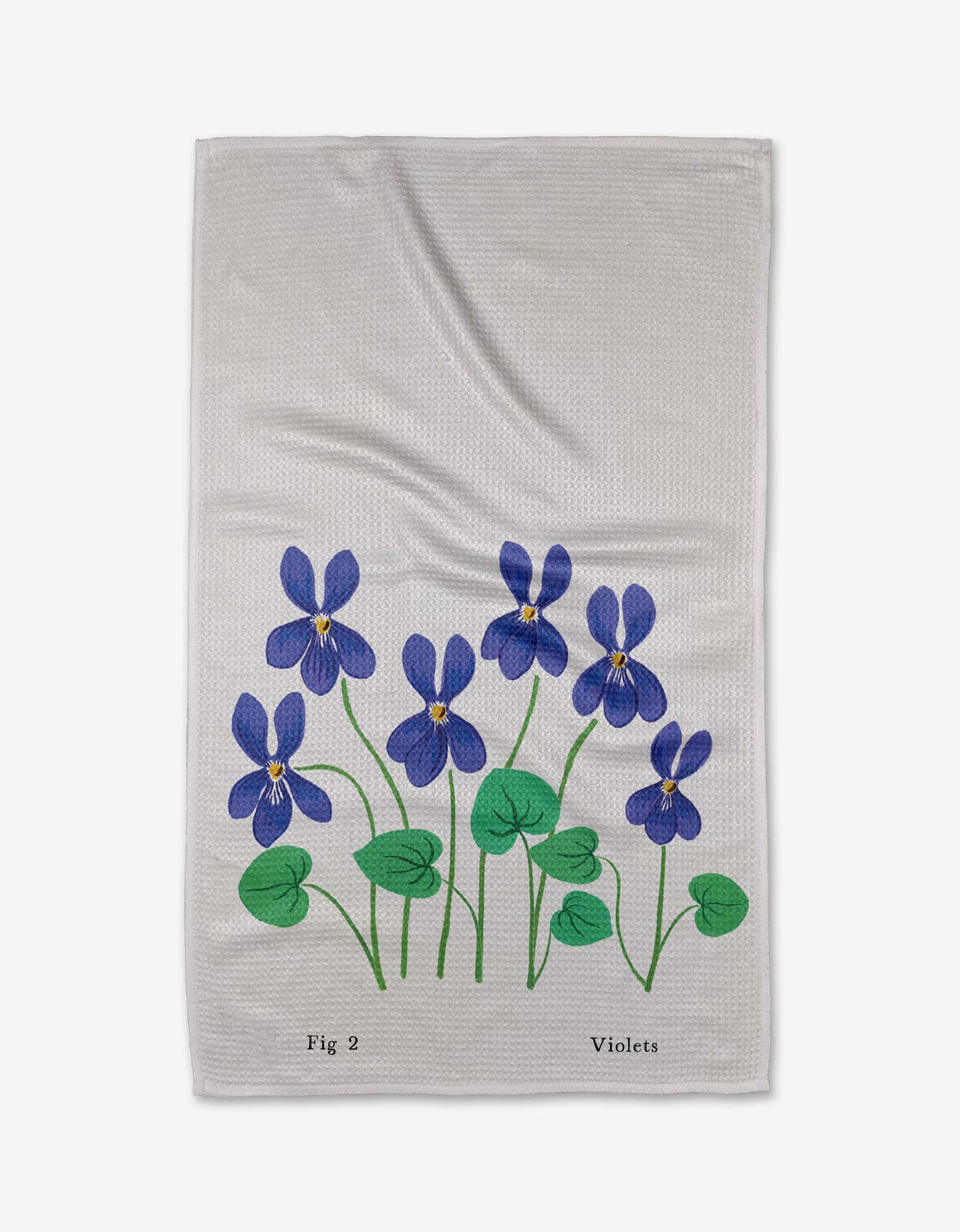 A white tea towel with decorative violets and the text ‘Fig 2, violets’ at the bottom on a white background.