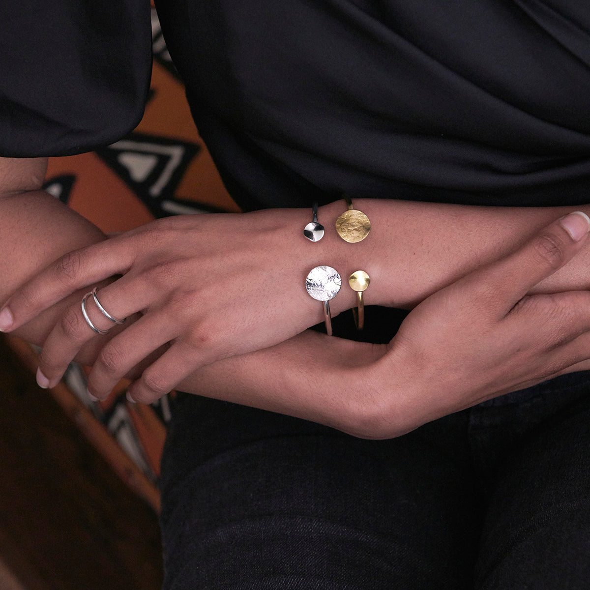 Styled image of model wearing the gold and silver Solaris Cuffs.
