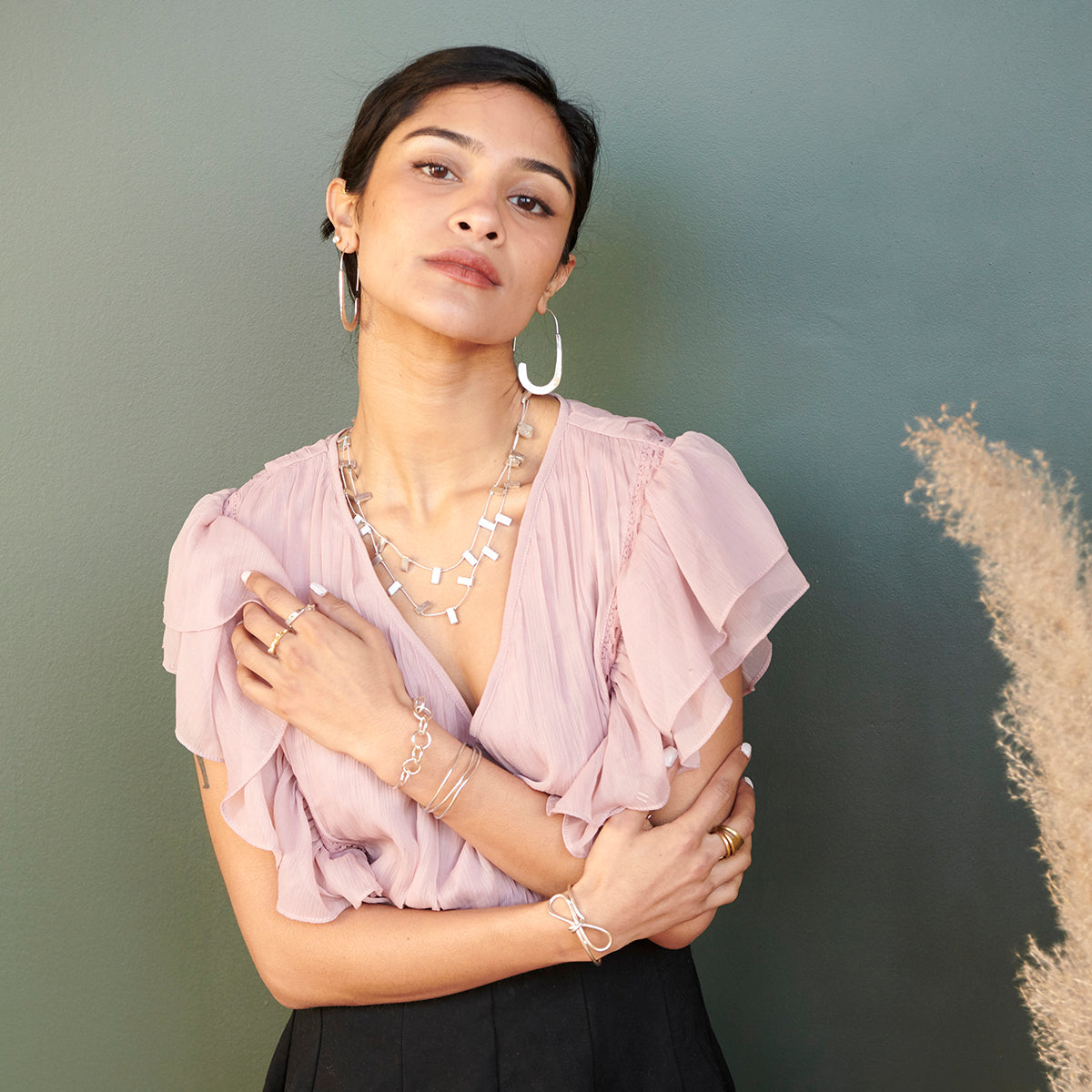 Image of model wearing the silver “Sculptural Bow” Cuff.