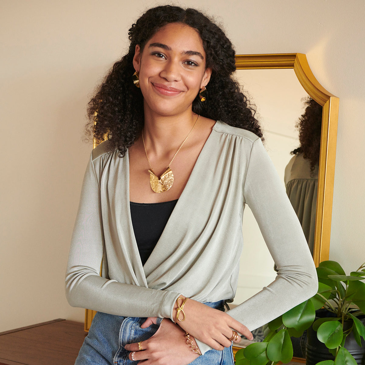 Photo of model wearing gold “Sculptural Bow” Cuff.