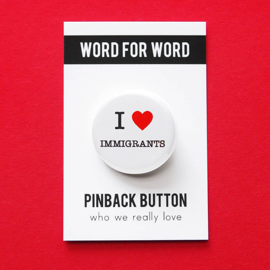 Pinback button with 'I heart Immigrants' text on a red background.