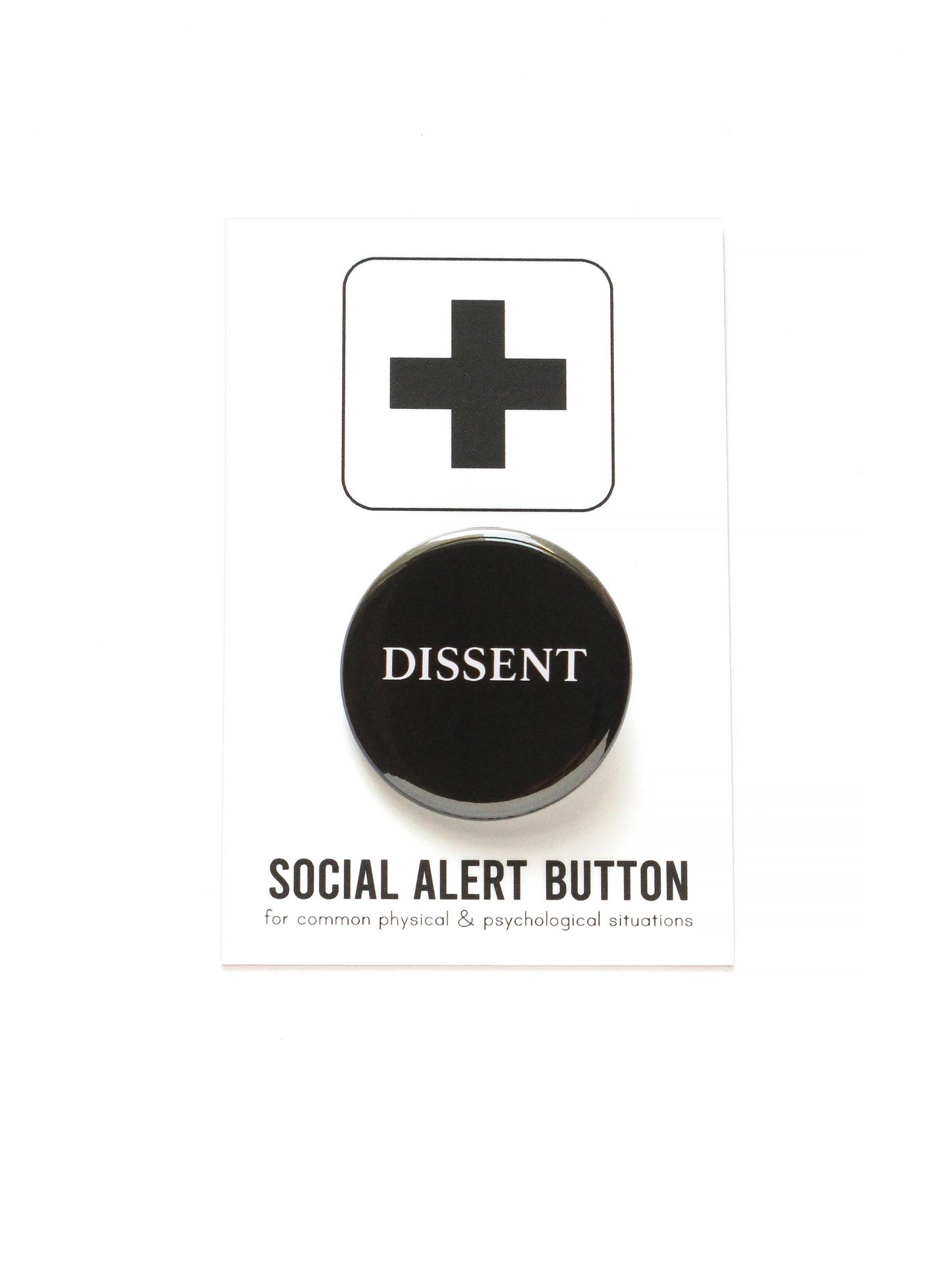 Black button with 'DISSENT' text on black and white ‘Social alert button for common physical & psychological situations’ packaging, on a white background