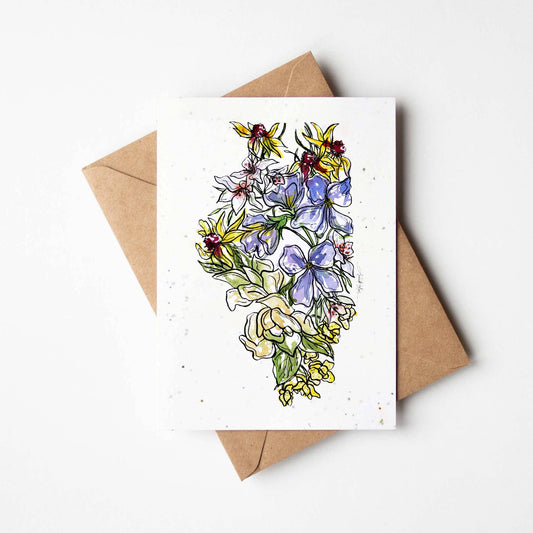A greeting card with a colorful floral artwork, accompanied by a brown kraft envelope.