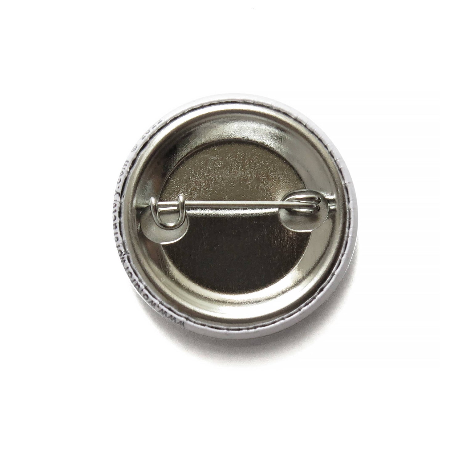 Back of button with metal pin on a white background.