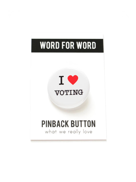 Button with 'I heart Voting' text on a black and white ‘Word for Word. Pinback button what we really love’ packaging. 