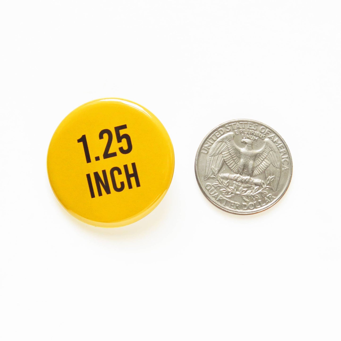 Yellow button with '1.25 INCH' text next to a U.S. quarter coin on a white background