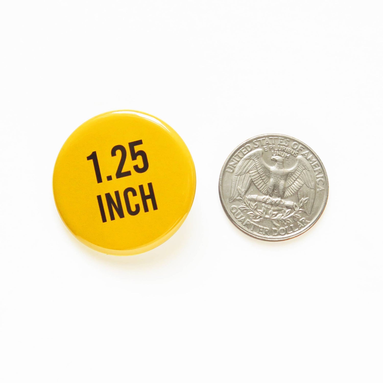 Yellow button with '1.25 INCH' text next to a U.S. quarter coin on a white background