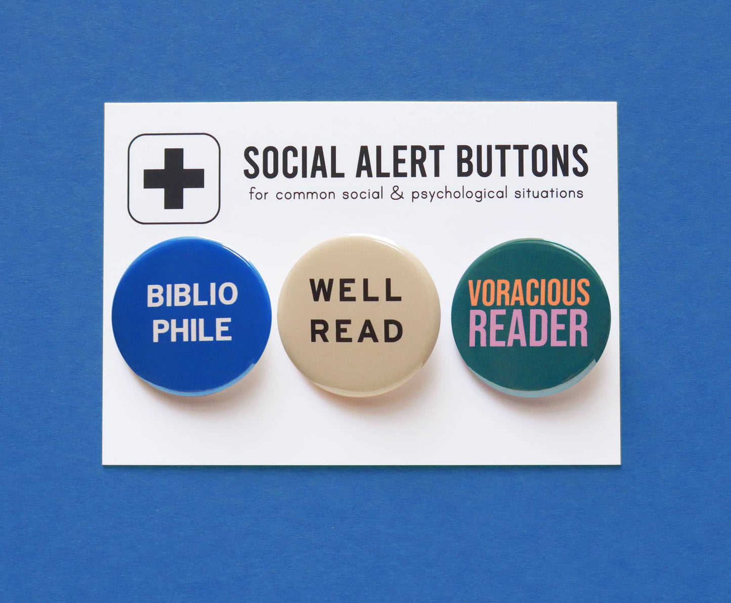 Three social alert buttons, One blue with “Bibliophile” one white with “Well Read” and a third blue-green with “Voracious reader”, on a card with a blue background