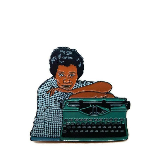 Enamel pin of Lorraine Hansberry next to a typewriter.