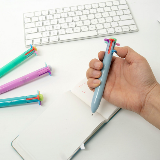 Image of a model using the Rainbow Flower Pen, with a notebook.