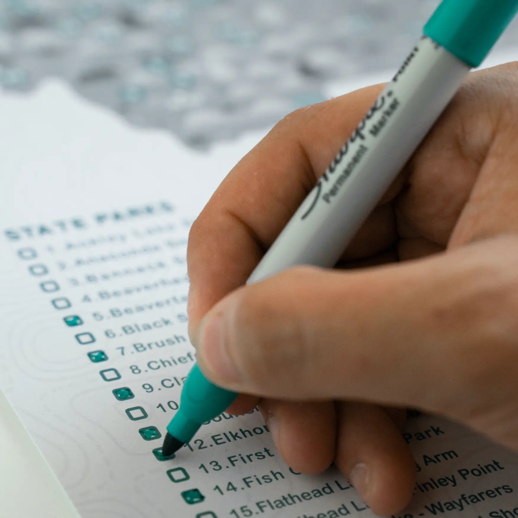 Photo of model filling in a check on the “Checklist” Illinois State Park Map.