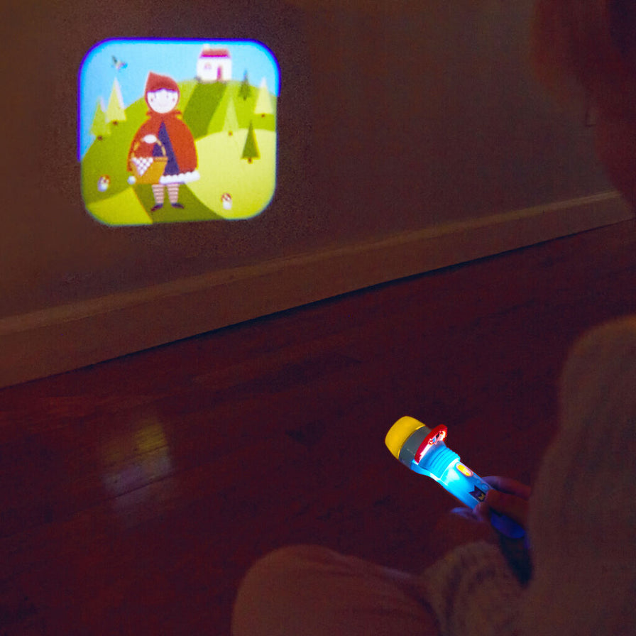 Image of model using the Storybook Flashlight, in the dark on a wall.