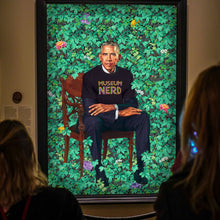 Load image into Gallery viewer, Fun image of Barack Obama painting, with him wearing a Museum Nerd tshirt.
