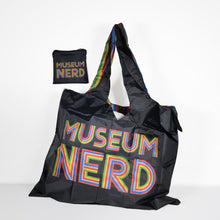 Load image into Gallery viewer, Museum Nerd tote bag next to matching storage bag.
