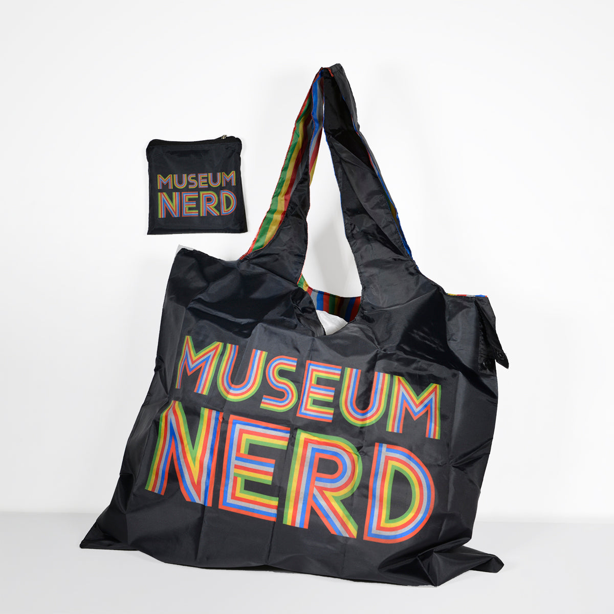 Museum Nerd tote bag next to matching storage bag.