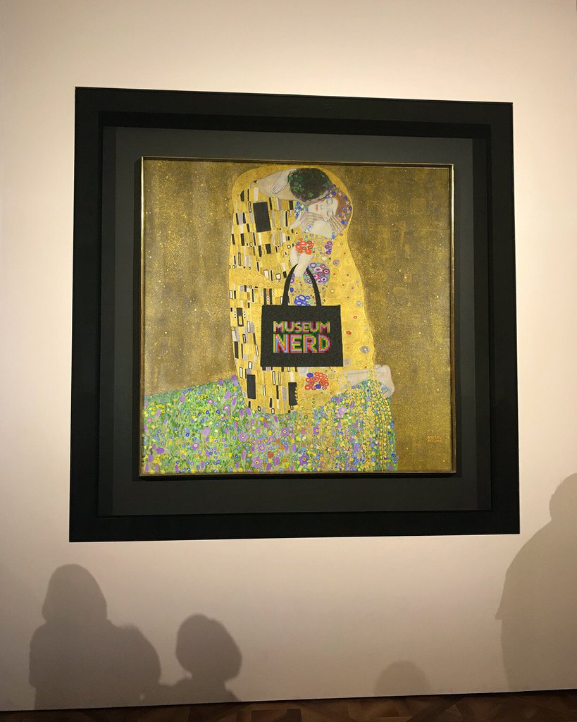 Klimt painting model holding Museum Nerd Laminated Tote bag.