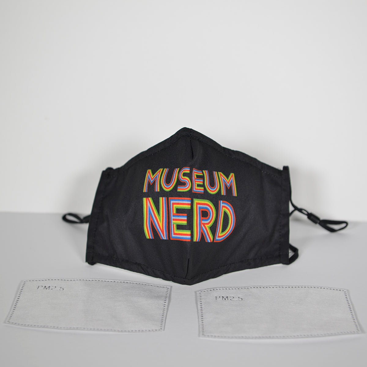 Museum Nerd Face Mask next to sewing size patterns.