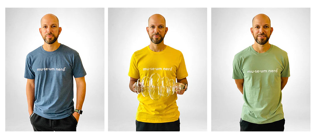 Model in yellow Museum Nerd 2.0 tshirt in front of white background.
