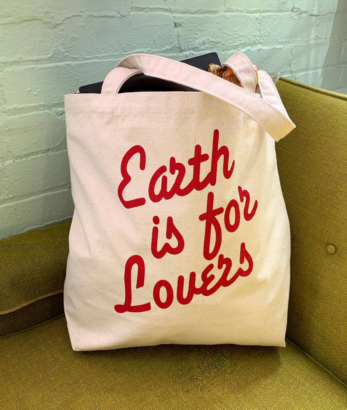 Earth is for Lovers Tote filled with items.