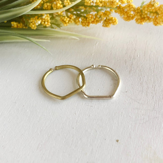 Photo of the gold and silver “Stackable” Rings, next to each other.