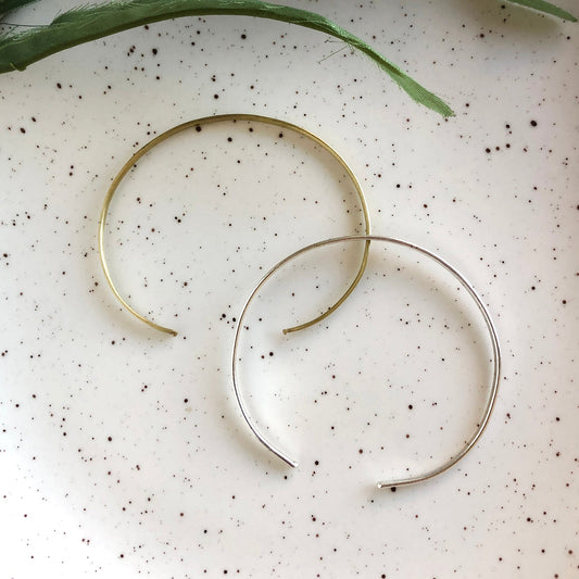 Photo of the gold and silver “Simple Band” Cuffs, next to each other.