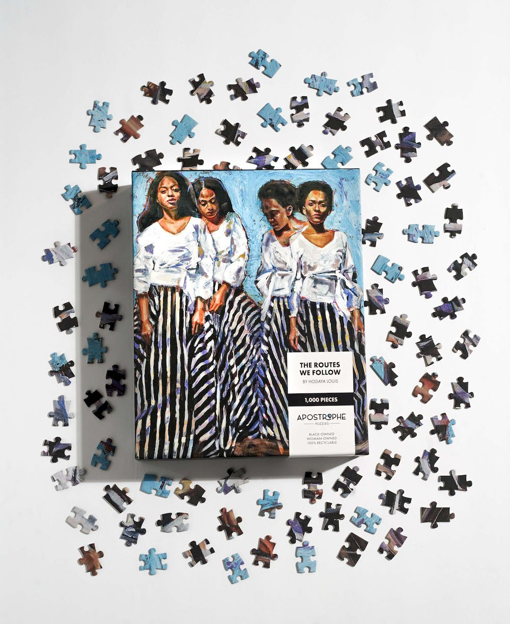 Photo of “The Routes We Follow” puzzle, in its packaging, next to sample puzzle pieces.