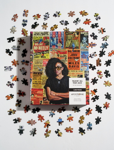 Photo of the “Talkin’ All That Jazz” puzzle, in its box, next to sample pieces.