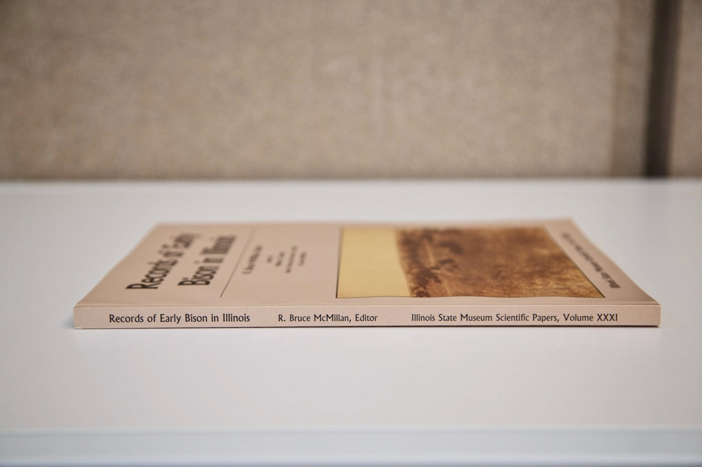 A flat, side view of the book “Records of Early Bison in Illinois.”