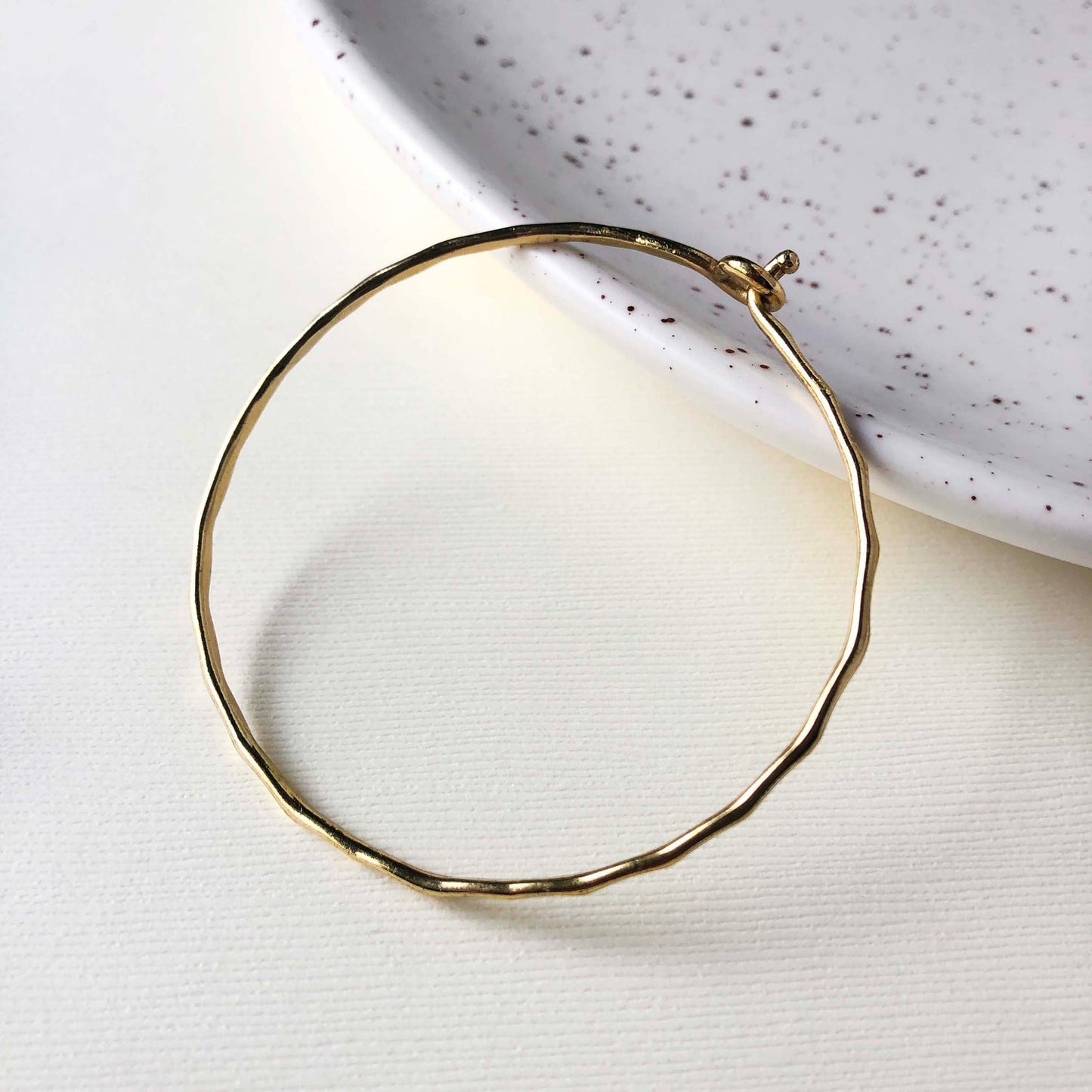 Photo of the gold “Interlocking Ripple” Bracelet.