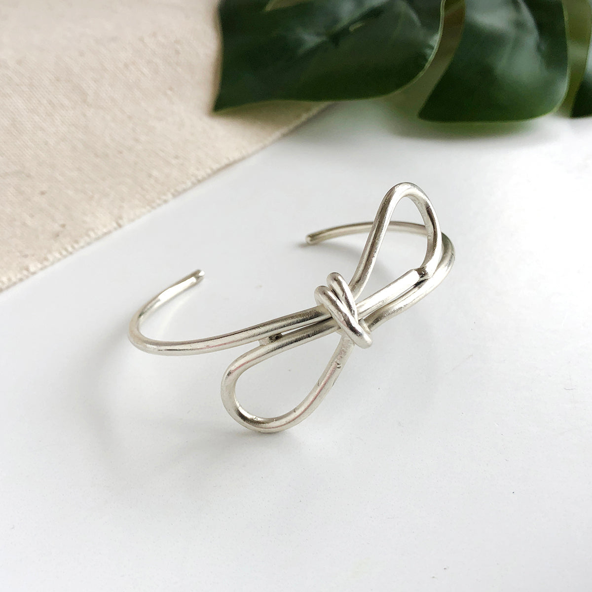 Product photo for the silver “Sculptural Bow” Cuff.
