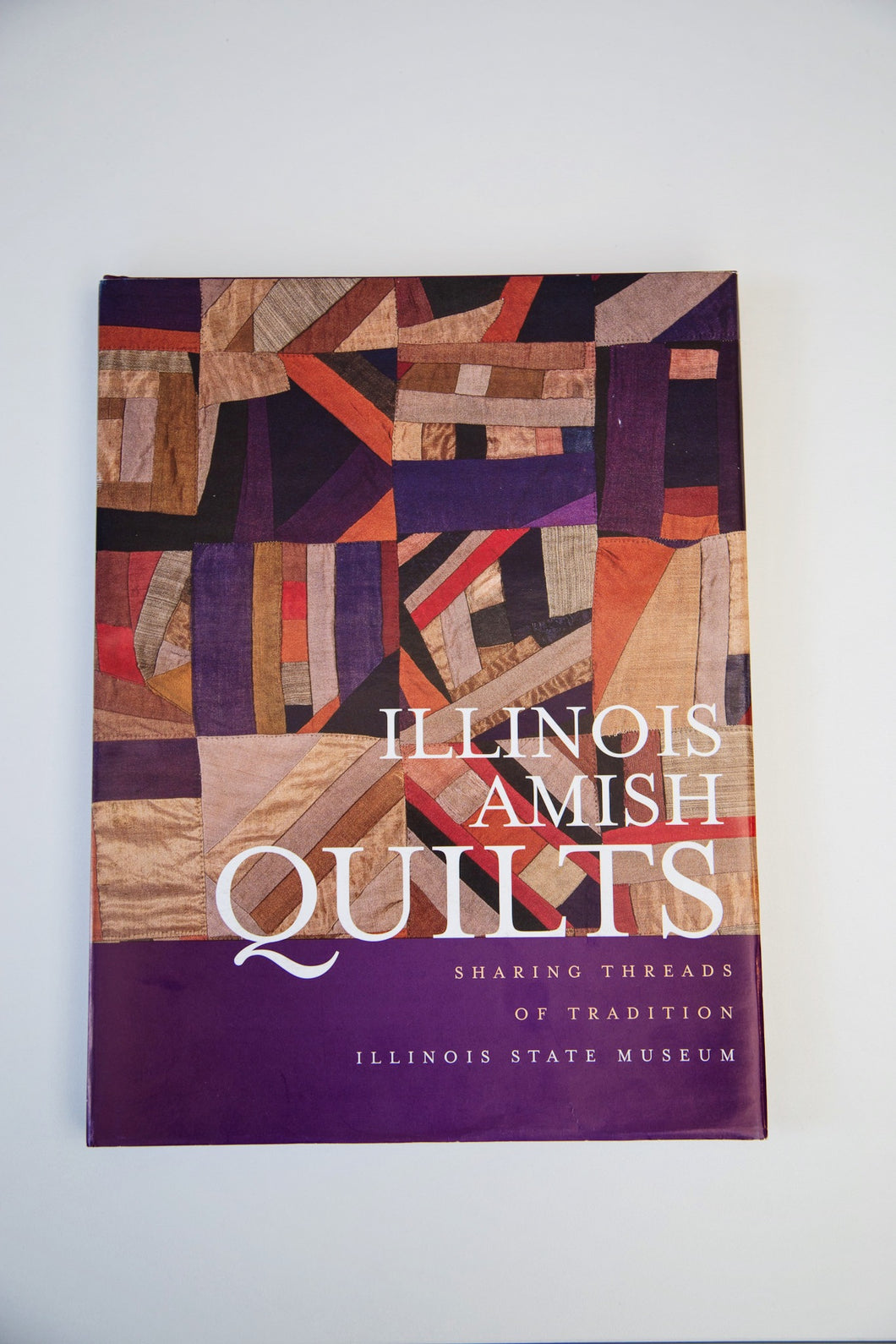 Image of the cover of the hard bound “Illinois Amish Quilts”.